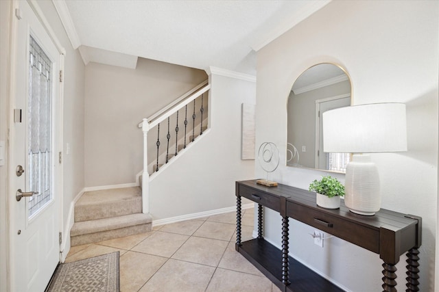 foyer with crown molding and light tile patterned flooring