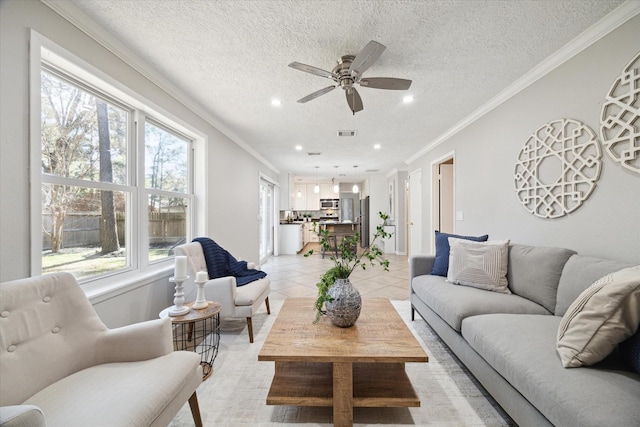 living room with crown molding, ceiling fan, a textured ceiling, and light tile patterned floors