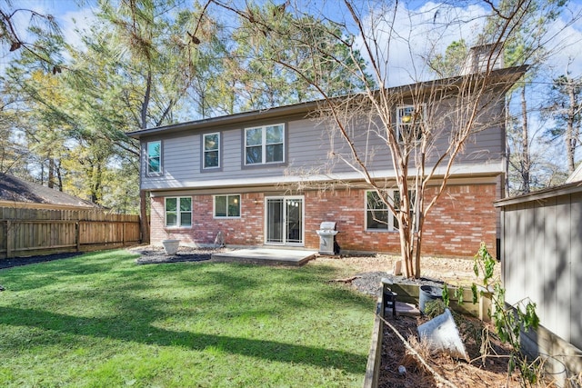 back of house featuring a patio area and a lawn