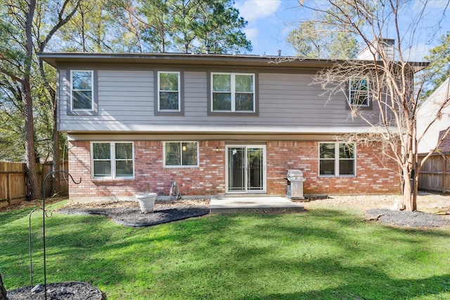 rear view of house featuring a yard and a patio area