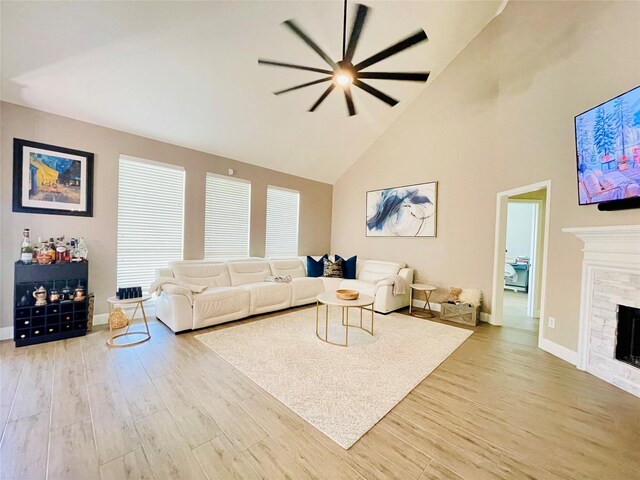 living room featuring high vaulted ceiling and light hardwood / wood-style floors