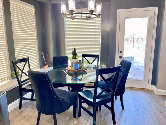 dining room featuring an inviting chandelier and light wood-type flooring