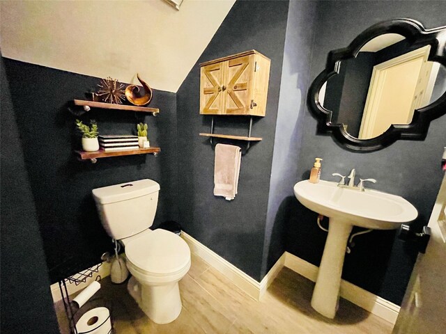 bathroom with sink, wood-type flooring, and toilet