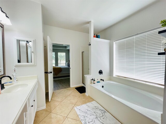 bathroom featuring tile patterned flooring, vanity, and separate shower and tub