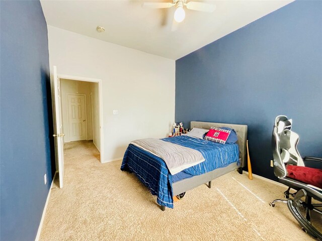 carpeted bedroom featuring lofted ceiling and ceiling fan