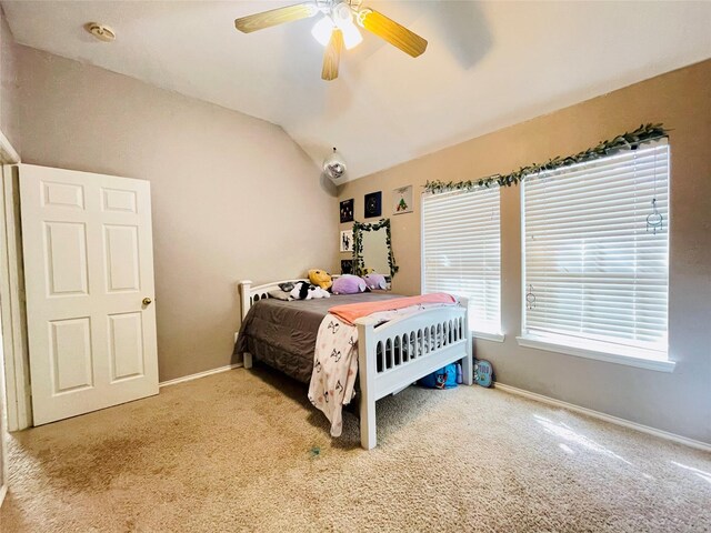 bedroom featuring carpet floors, vaulted ceiling, and ceiling fan