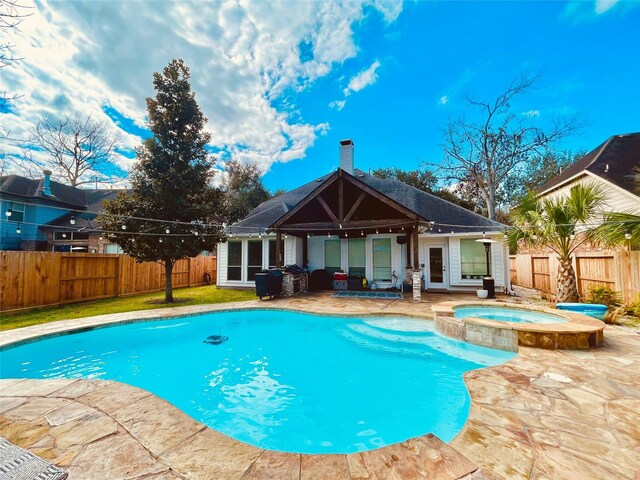 view of pool with an in ground hot tub and a patio