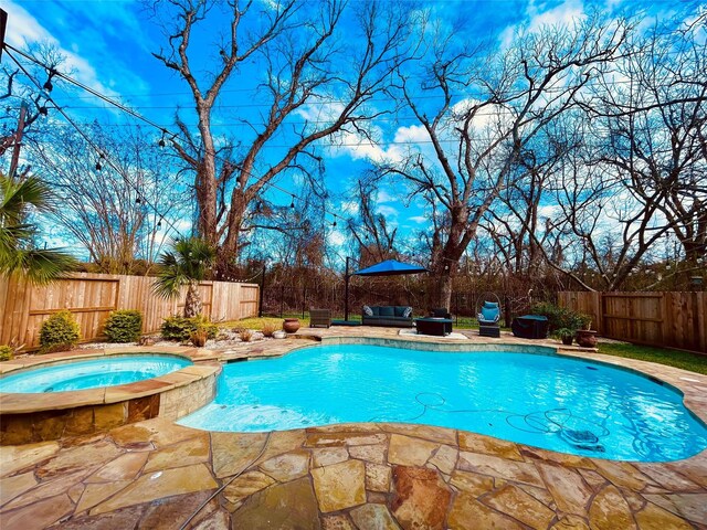 view of swimming pool featuring an outdoor living space, an in ground hot tub, and a patio area