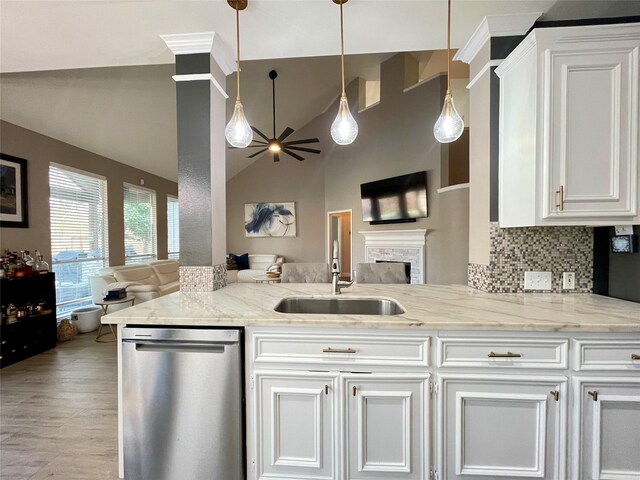 kitchen with white cabinetry, stainless steel dishwasher, and light stone counters