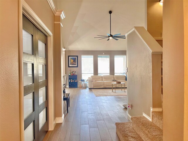 corridor featuring vaulted ceiling and light hardwood / wood-style floors