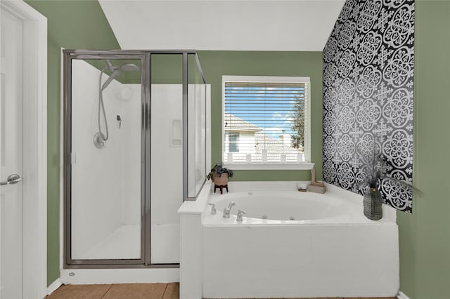 bathroom featuring lofted ceiling, tile patterned floors, and plus walk in shower