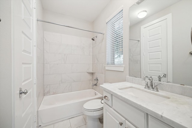 full bathroom with tiled shower / bath, vanity, toilet, and tile patterned floors