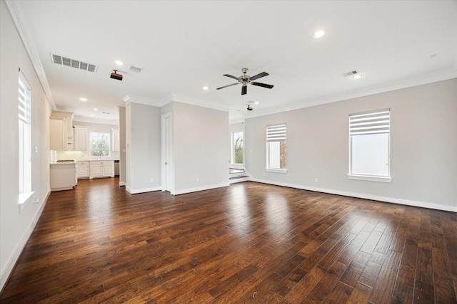 unfurnished living room featuring dark wood-type flooring, ceiling fan, ornamental molding, and a wealth of natural light