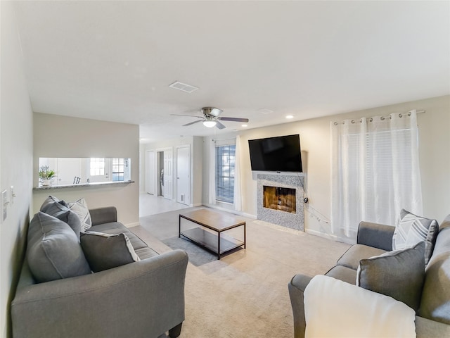 living room featuring light carpet and ceiling fan