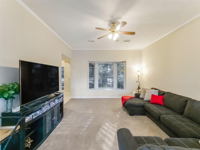 living room featuring ornamental molding, ceiling fan, and carpet