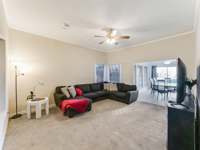 living room with crown molding, light carpet, and ceiling fan