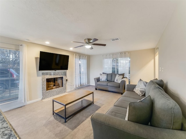 carpeted living room with a wealth of natural light and ceiling fan