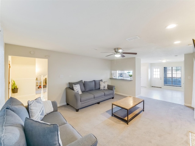 living room featuring light carpet and ceiling fan