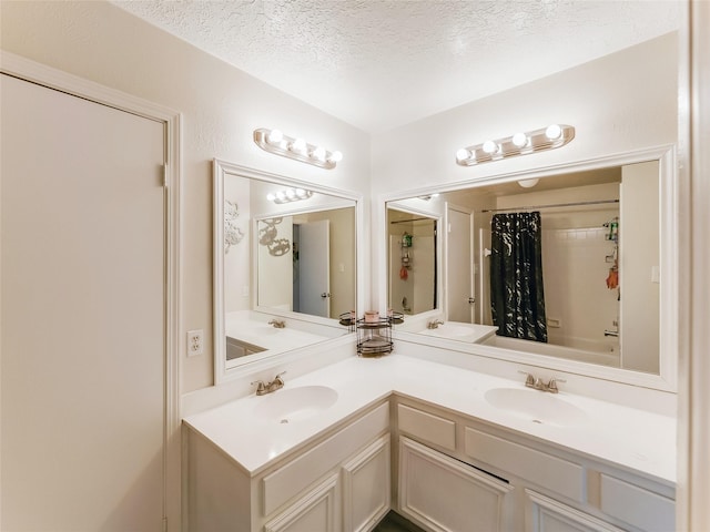 bathroom featuring shower / tub combo, vanity, and a textured ceiling