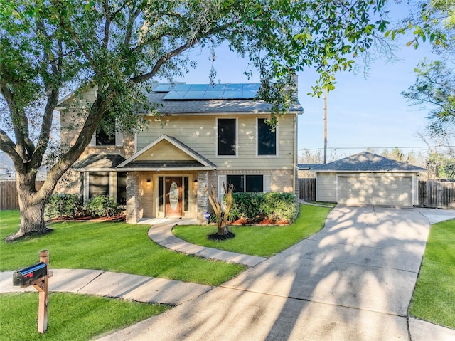 view of front of house with a garage, an outbuilding, a front yard, and solar panels