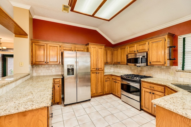 kitchen featuring appliances with stainless steel finishes, kitchen peninsula, light stone counters, and decorative backsplash