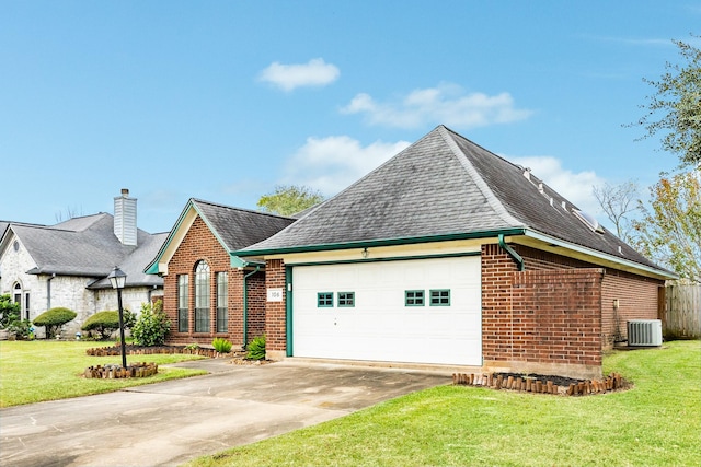 view of front facade featuring a garage, a front yard, and central AC unit