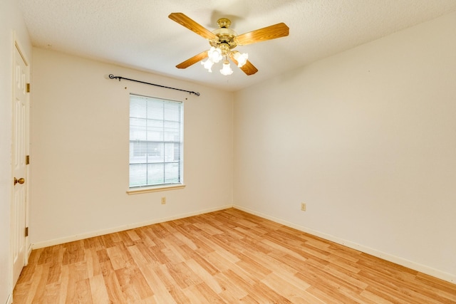 unfurnished room featuring ceiling fan, light hardwood / wood-style flooring, and a textured ceiling