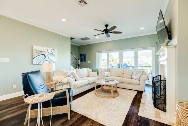 living room featuring wood-type flooring, ceiling fan, and crown molding