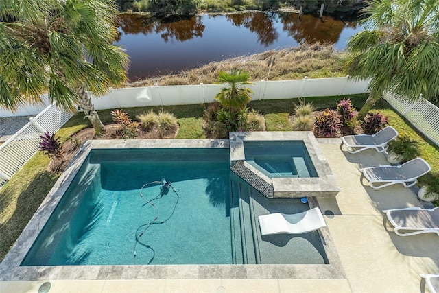 view of swimming pool with an in ground hot tub and a water view