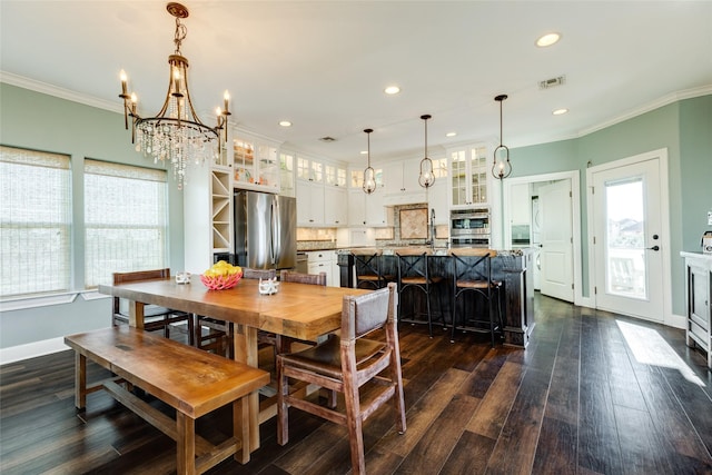 dining space featuring a notable chandelier, ornamental molding, dark hardwood / wood-style floors, and a wealth of natural light