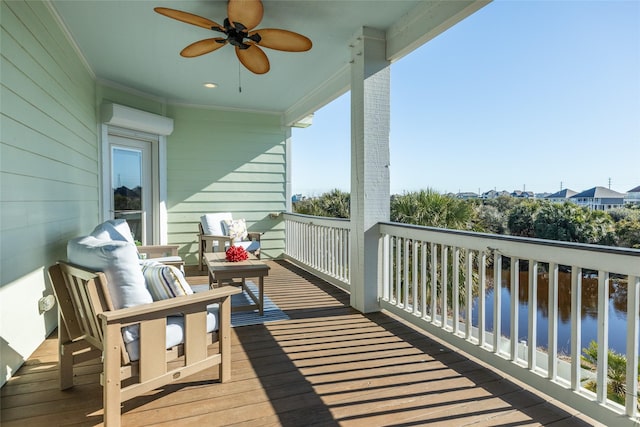 balcony with a water view and ceiling fan