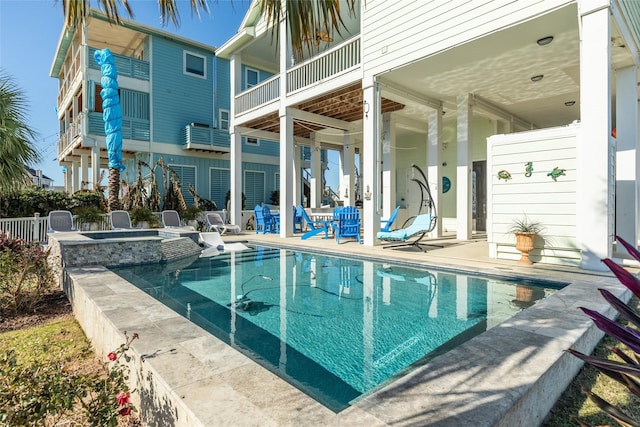 view of swimming pool featuring a patio and an in ground hot tub