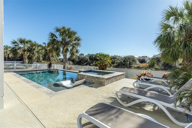 view of swimming pool featuring a patio area and an in ground hot tub