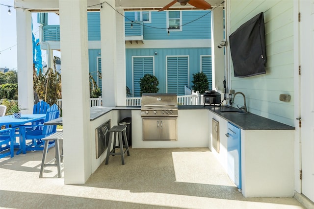 view of patio / terrace featuring ceiling fan, area for grilling, and an outdoor wet bar