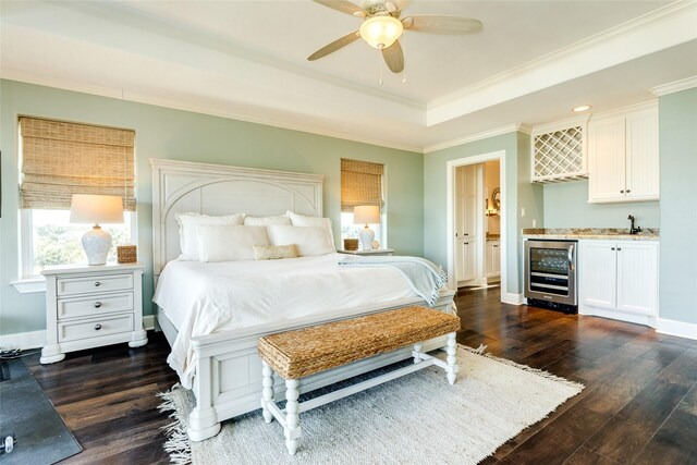 bedroom with dark wood-type flooring, ceiling fan, ornamental molding, wet bar, and beverage cooler