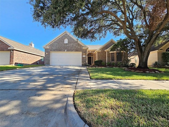 single story home featuring a garage and a front lawn