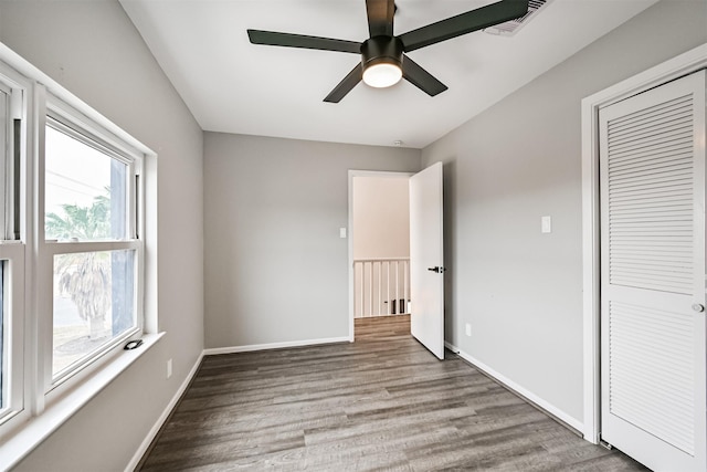 unfurnished bedroom with light hardwood / wood-style floors, a closet, and ceiling fan