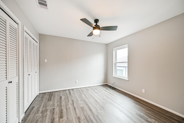 unfurnished bedroom featuring hardwood / wood-style floors and ceiling fan