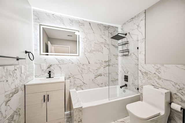 full bathroom featuring tile walls, vanity, toilet, and washtub / shower combination