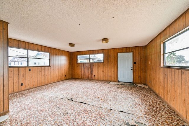 unfurnished room with a textured ceiling