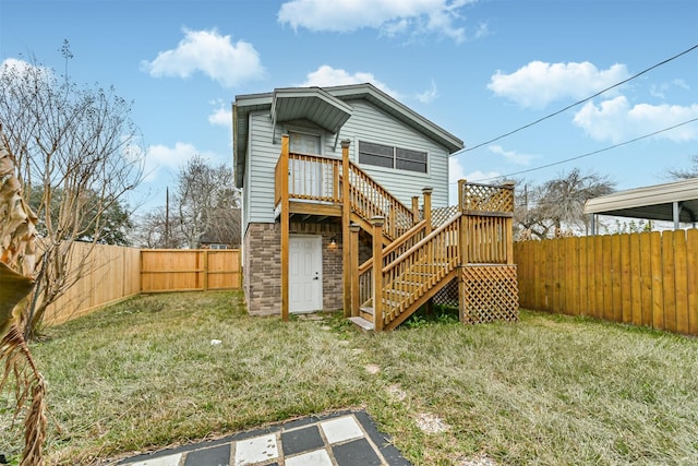 rear view of property with a lawn