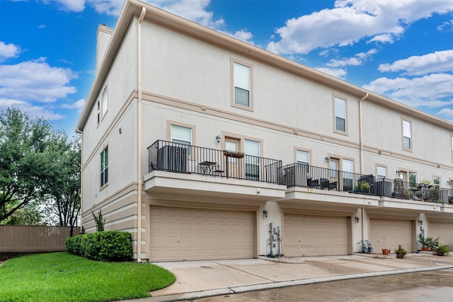 view of front of home with a balcony and a garage