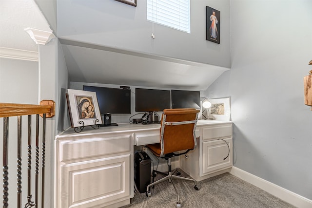 office space featuring ornamental molding, light carpet, and built in desk