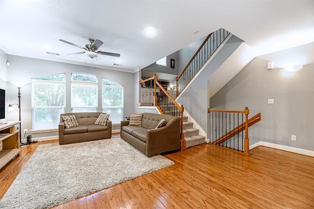 living room with crown molding, ceiling fan, and hardwood / wood-style flooring