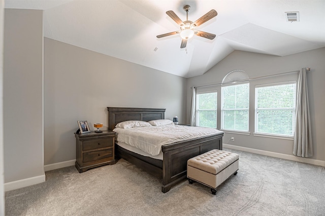 carpeted bedroom with ceiling fan and vaulted ceiling