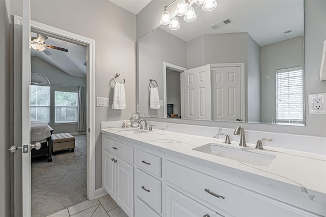 bathroom featuring tile patterned flooring, vanity, lofted ceiling, and ceiling fan