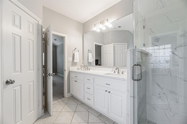 bathroom featuring vanity, tile patterned floors, and a shower with shower door