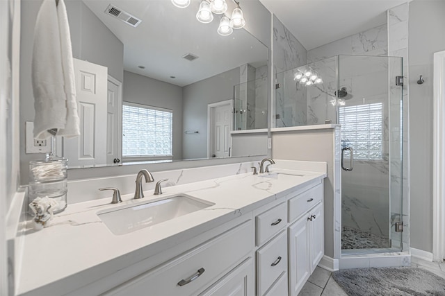 bathroom featuring vanity, an enclosed shower, and tile patterned floors