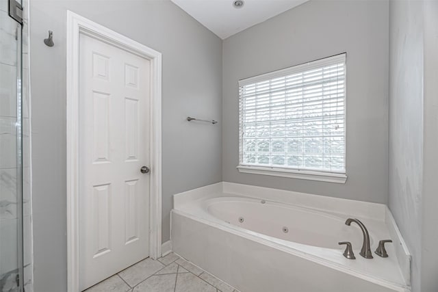 bathroom featuring tile patterned flooring and a washtub