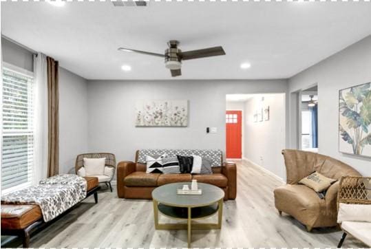 living room featuring ceiling fan and light wood-type flooring